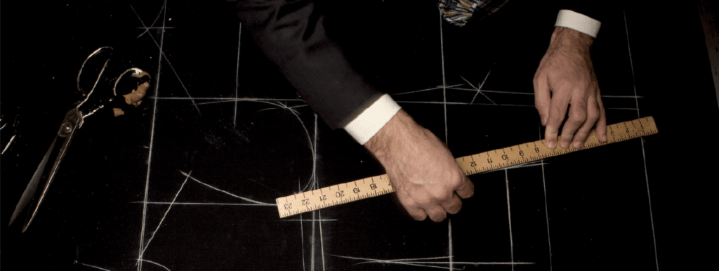 Bespoke vs. made to measure, Tailor marking pattern on fabric - custom suits nyc bespoke tailor midtown, noho